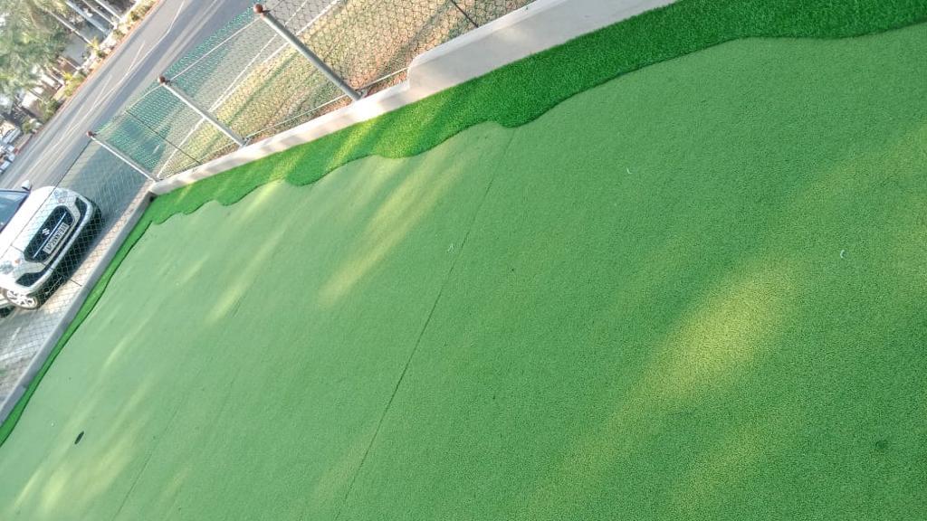 Turf court with perimeter fencing