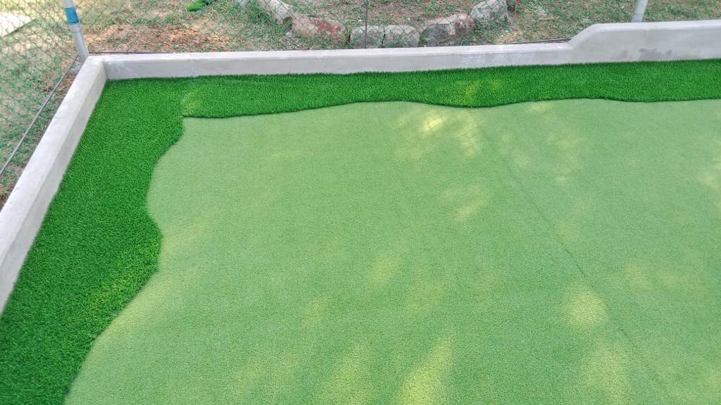 Artificial turf laid along the court edge